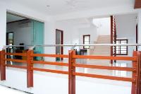 detail of the wood and stainless steel railing around the atrium at the first floor.